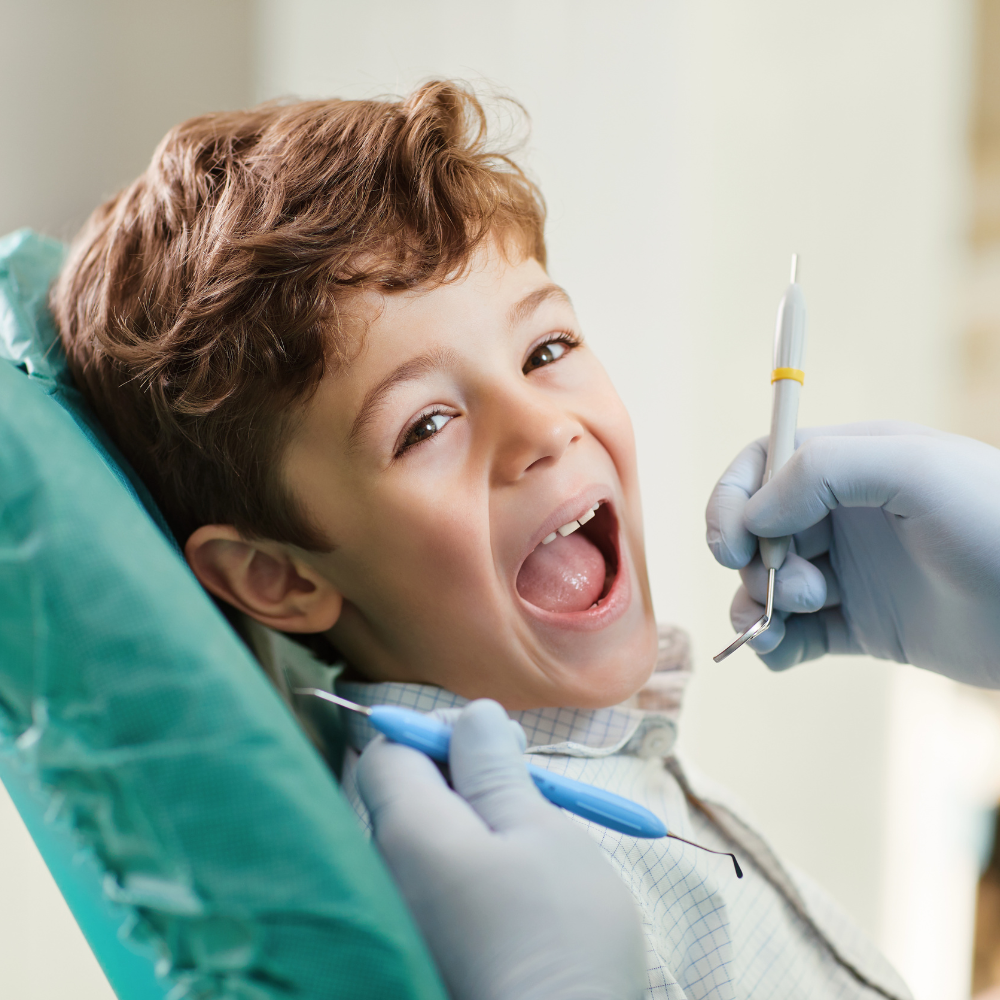 Kid smiling in dentist chair
