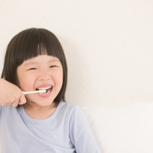 Young child brushing teeth